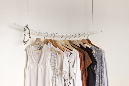 Assorted clothes in wooden hangers